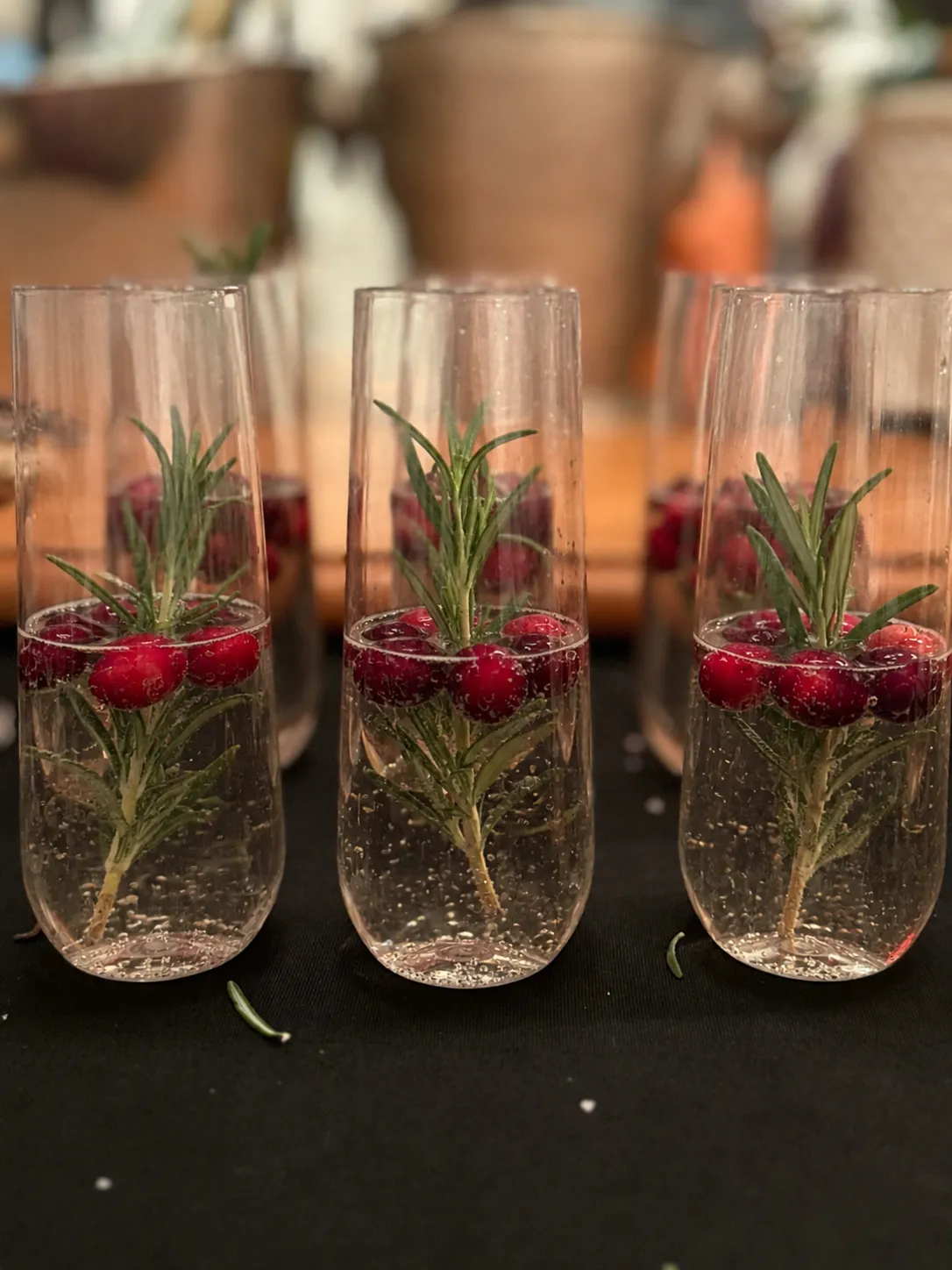 Custom cocktails finished with fresh berries and rosemary