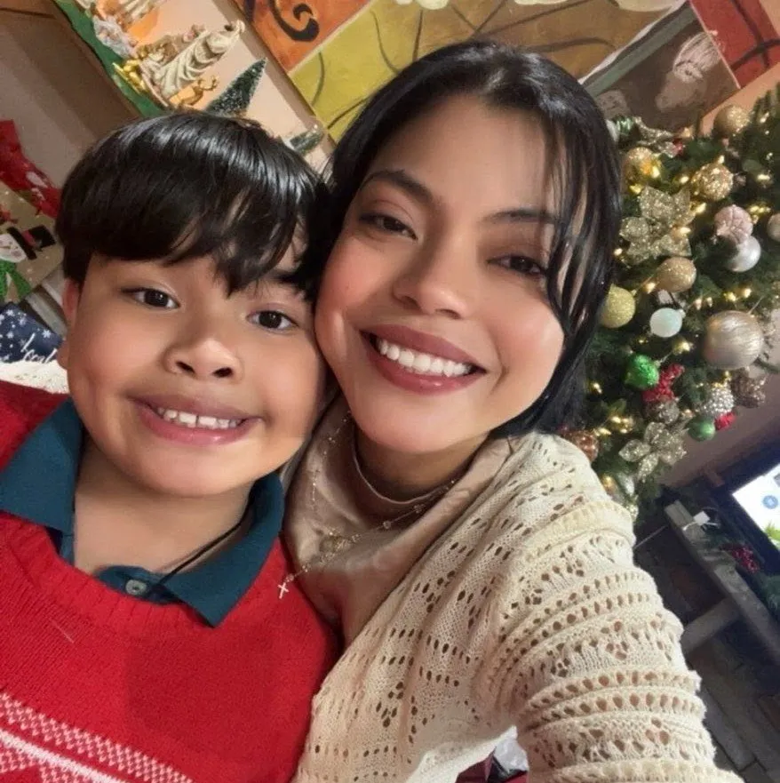 A mother and child smiling together during a holiday celebration